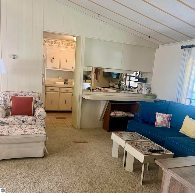 living room featuring lofted ceiling and light colored carpet