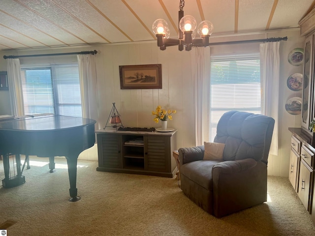 sitting room with carpet flooring, a chandelier, and a textured ceiling