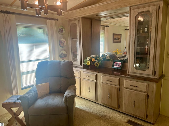 living area featuring light carpet and vaulted ceiling