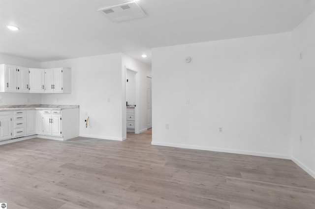 interior space featuring white cabinetry and light wood-type flooring