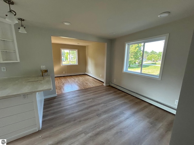 interior space featuring hardwood / wood-style flooring and baseboard heating