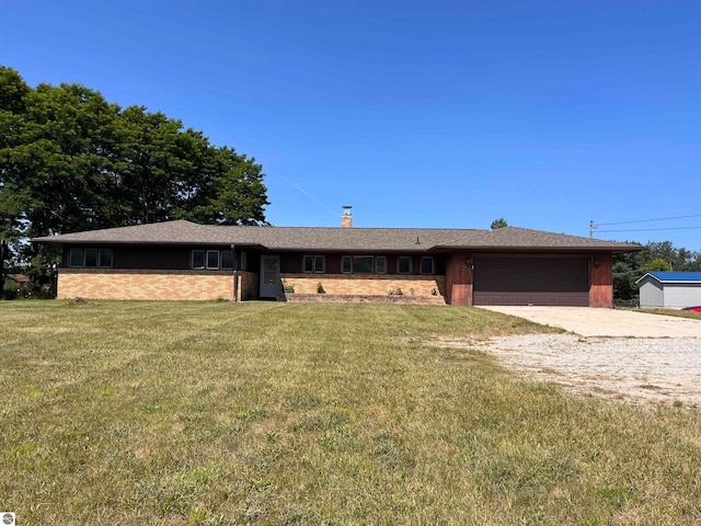 view of front of house with a garage and a front lawn