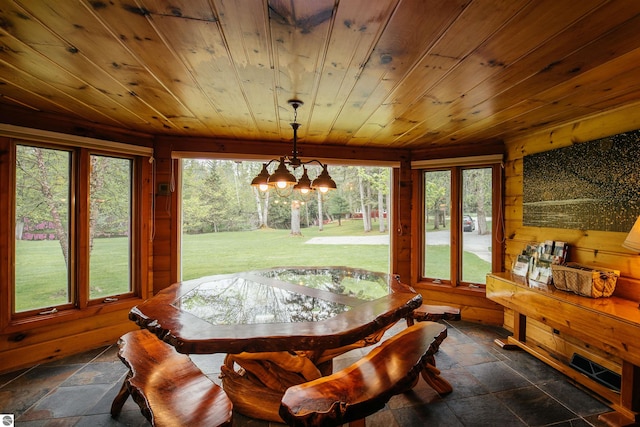 tiled dining area with a healthy amount of sunlight, wooden ceiling, and a notable chandelier