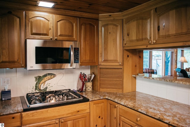 kitchen featuring stainless steel appliances and tasteful backsplash