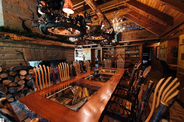 dining area with vaulted ceiling with beams, a chandelier, and wooden ceiling