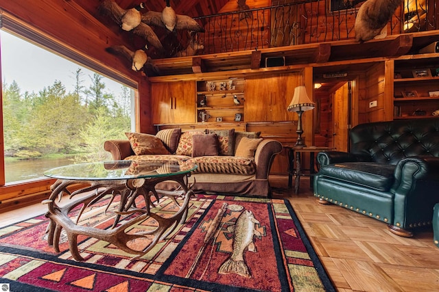 living room with wood walls and light parquet flooring