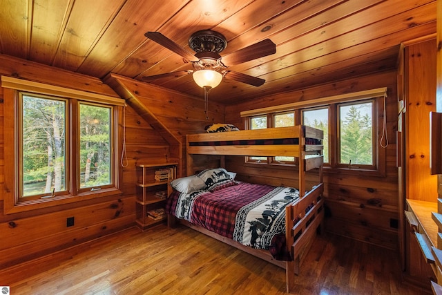 bedroom featuring wooden walls, hardwood / wood-style flooring, and wood ceiling