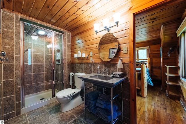 bathroom featuring hardwood / wood-style flooring, toilet, a shower with door, and wood ceiling