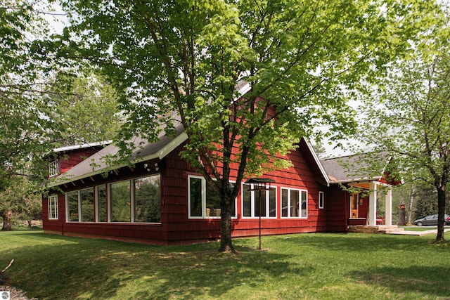 view of property exterior featuring a lawn