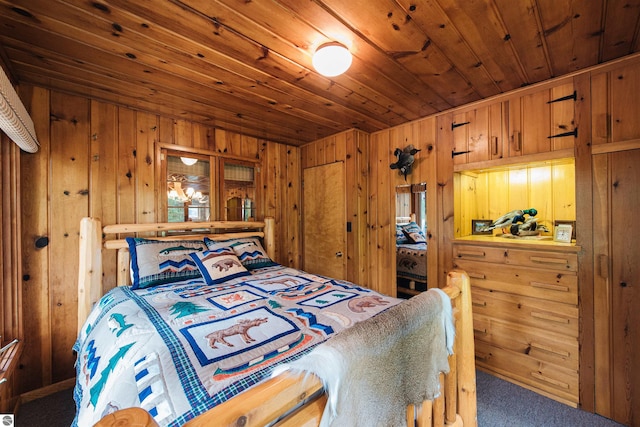 bedroom featuring carpet flooring, wood walls, and wooden ceiling