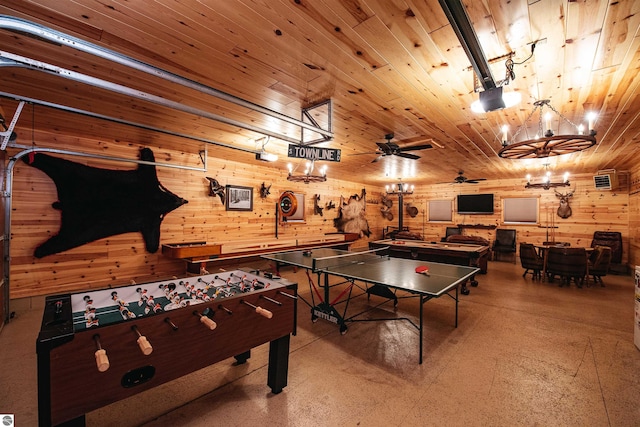 recreation room with ceiling fan with notable chandelier and wood ceiling