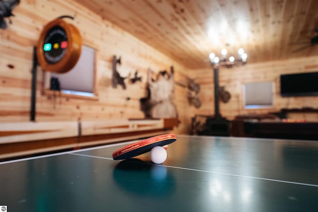 recreation room featuring wood walls and wood ceiling