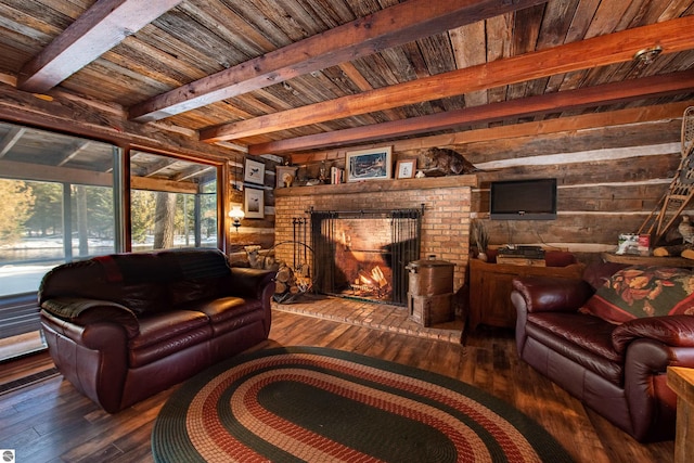 living room with beam ceiling, dark hardwood / wood-style flooring, a brick fireplace, and wood ceiling