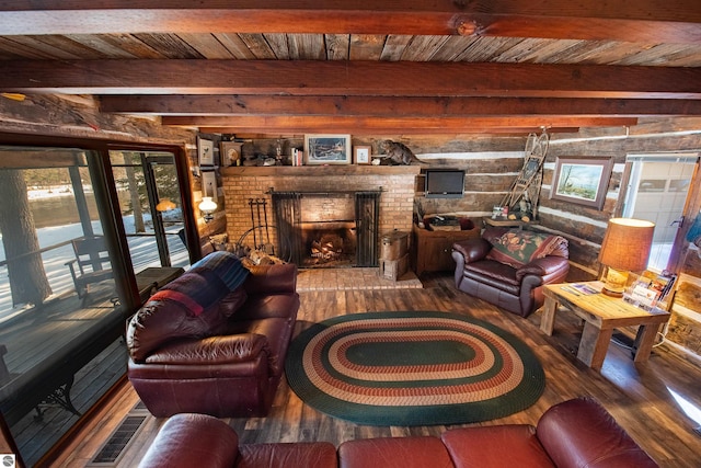 living room featuring beamed ceiling, a fireplace, hardwood / wood-style floors, and wood ceiling