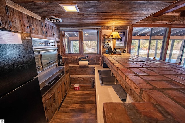 kitchen with wood ceiling, oven, dark hardwood / wood-style floors, tile countertops, and refrigerator