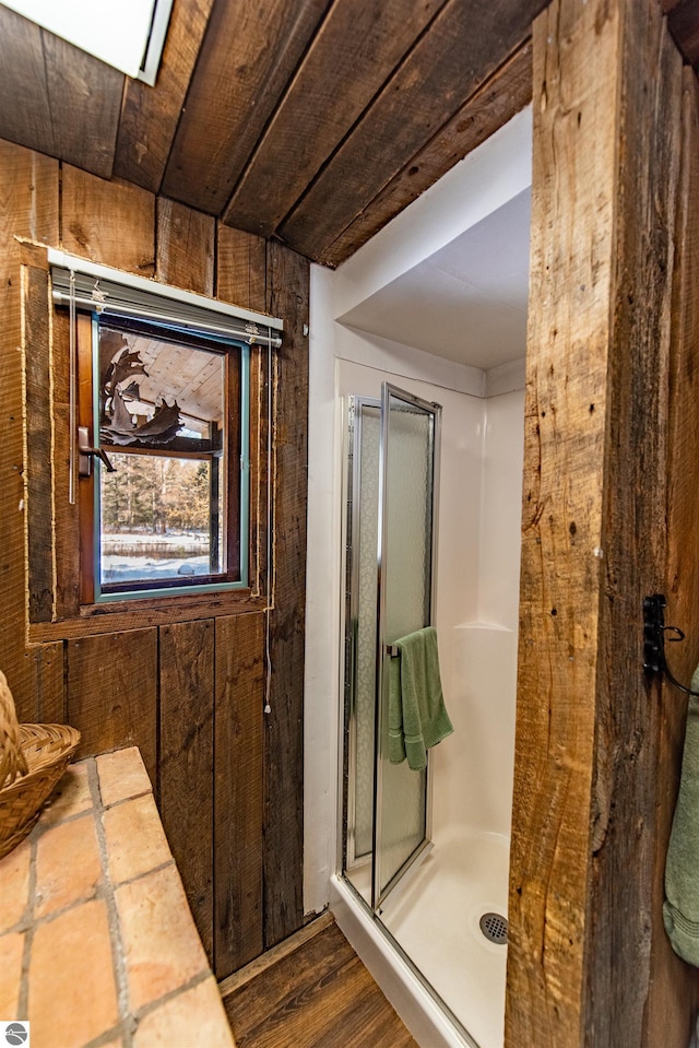 bathroom with walk in shower, wood walls, wooden ceiling, and hardwood / wood-style floors