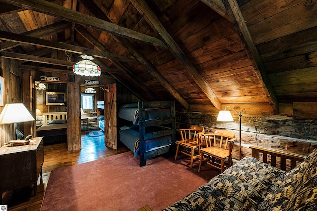 bedroom with lofted ceiling with beams, wood ceiling, wooden walls, and hardwood / wood-style floors