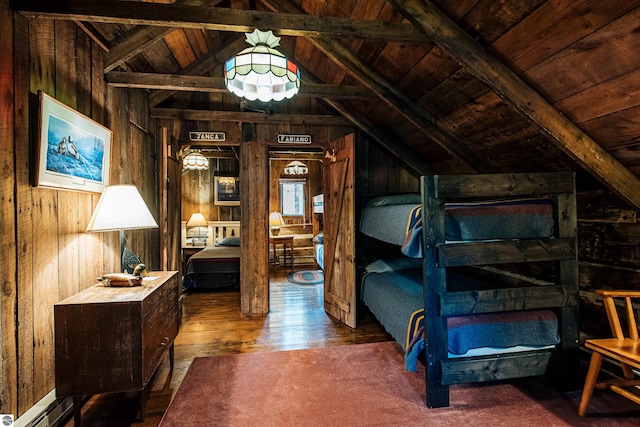 bedroom with lofted ceiling with beams, wooden ceiling, wooden walls, and hardwood / wood-style floors