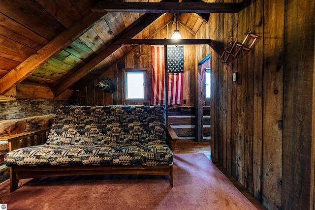 carpeted bedroom featuring wood ceiling, wooden walls, and vaulted ceiling with beams