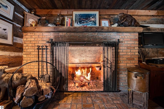 room details with wooden ceiling, a fireplace, and beam ceiling