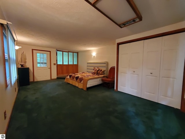 unfurnished bedroom featuring dark colored carpet and a closet