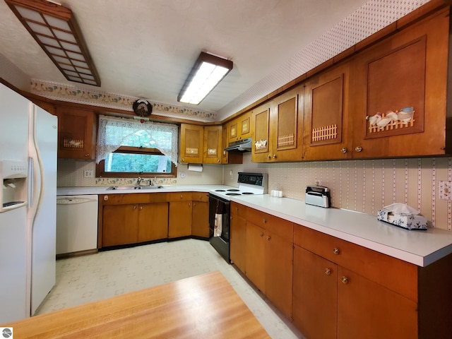 kitchen with sink and white appliances