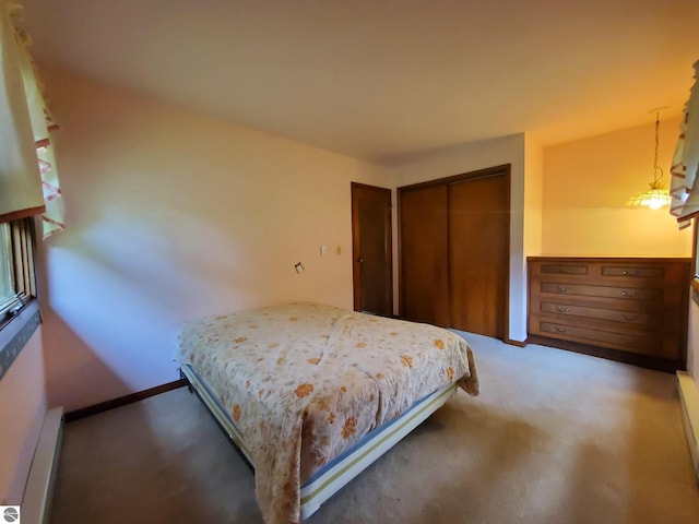 bedroom featuring carpet floors, a closet, and a baseboard heating unit