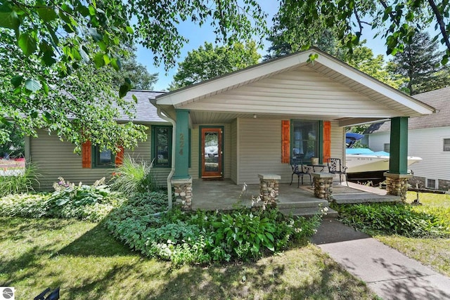 224 Saint Marys St, Suttons Bay, MI 49682 - bungalow-style house with covered porch