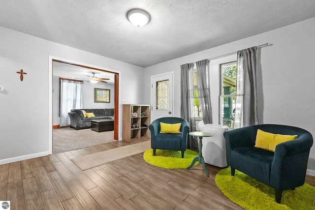 224 Saint Marys St, Suttons Bay, MI 49682 - sitting room with wood finished floors, baseboards, and a textured ceiling
