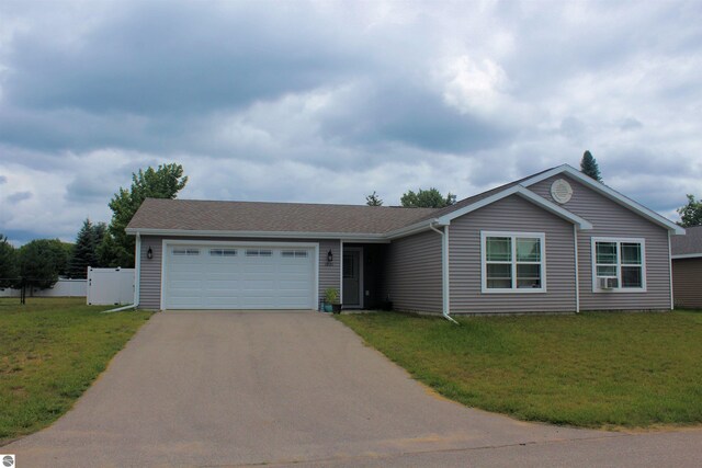 ranch-style house with a garage and a front lawn