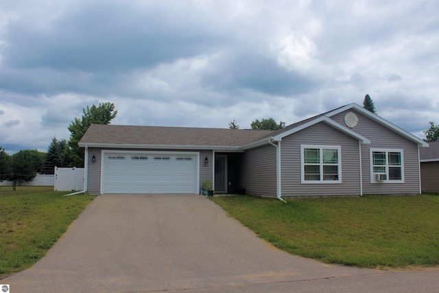 single story home featuring fence, a front yard, aphalt driveway, and a garage