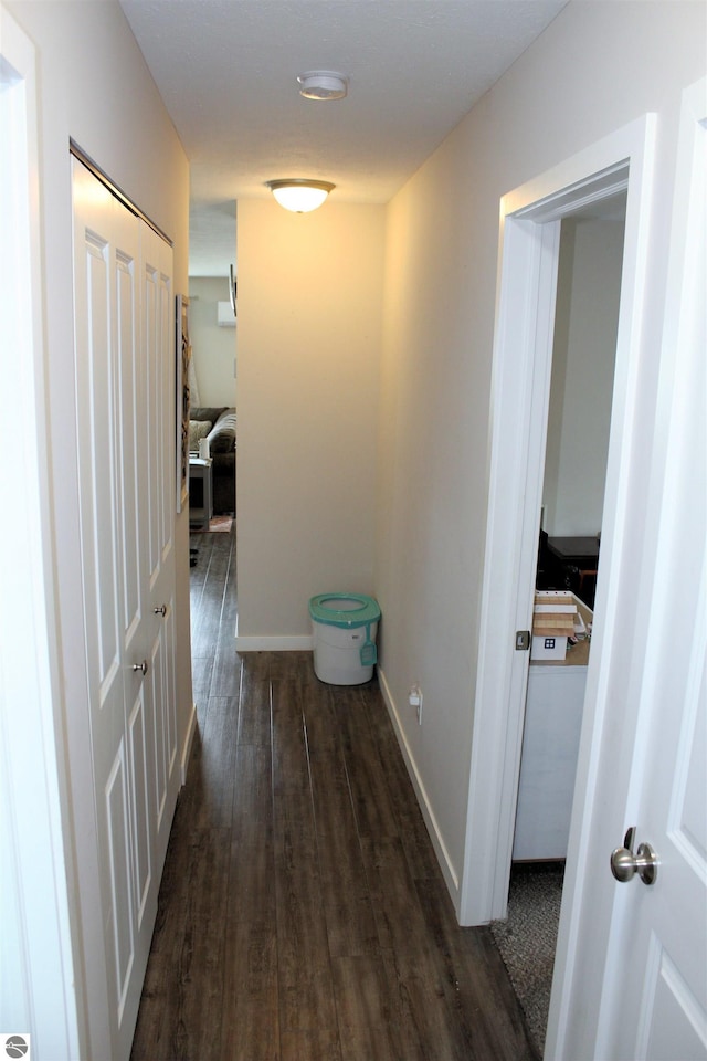 hallway with dark wood-type flooring