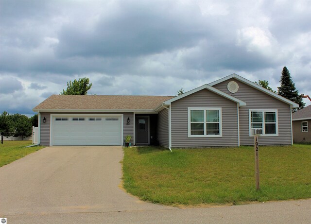 ranch-style home with a garage and a front yard