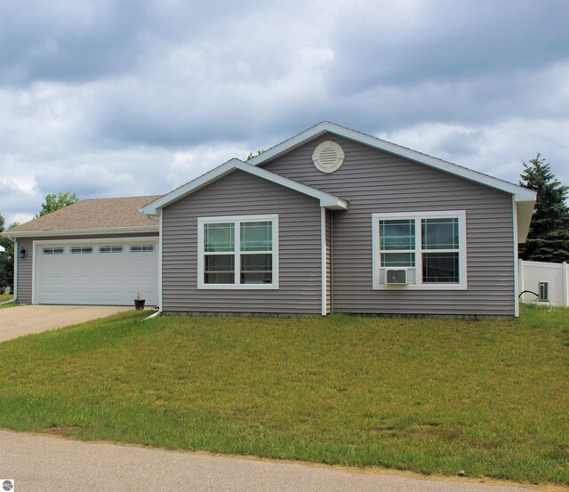 ranch-style house featuring cooling unit, a garage, and a front lawn