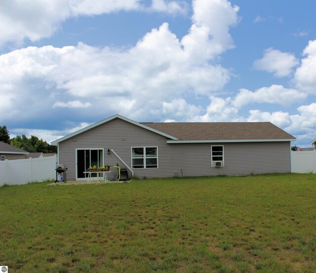 back of house with a lawn