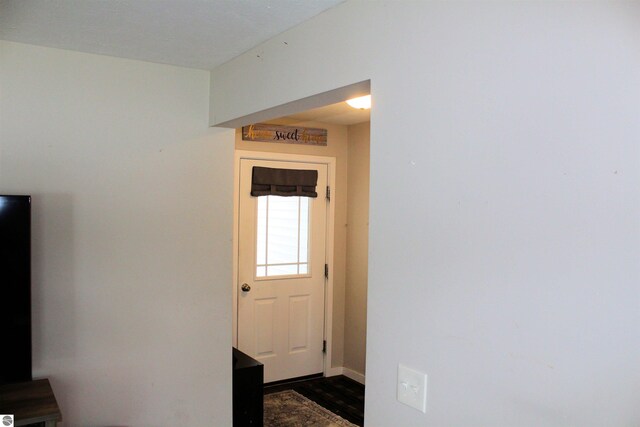 entryway with dark hardwood / wood-style floors