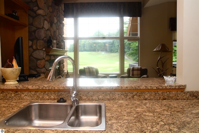 kitchen featuring sink and a fireplace