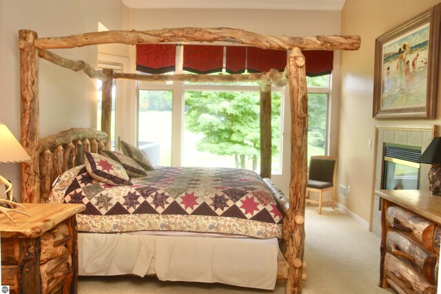 bedroom featuring a fireplace and multiple windows