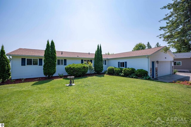 ranch-style home featuring a garage and a front lawn