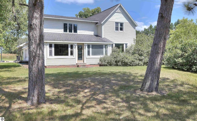 view of property featuring a garage and a front lawn