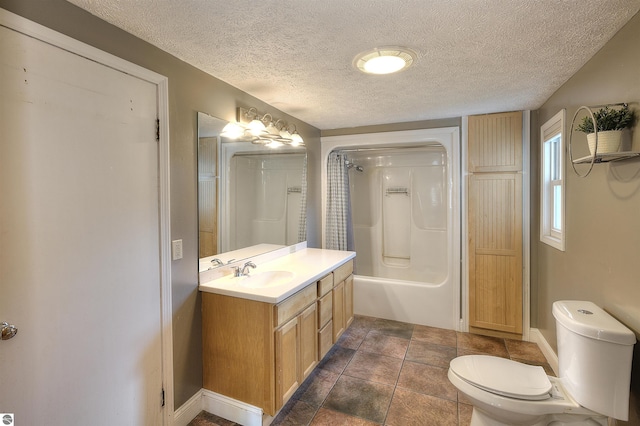 bathroom with vanity, toilet, a textured ceiling, and walk in shower