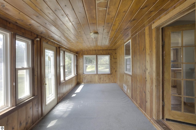 unfurnished sunroom with plenty of natural light and wooden ceiling