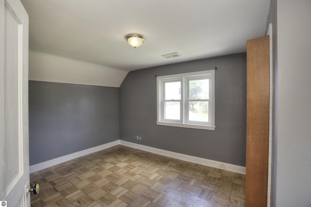 bonus room featuring vaulted ceiling and light parquet floors