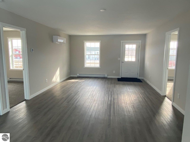 foyer entrance featuring dark wood-type flooring, baseboard heating, a baseboard radiator, and a wall unit AC