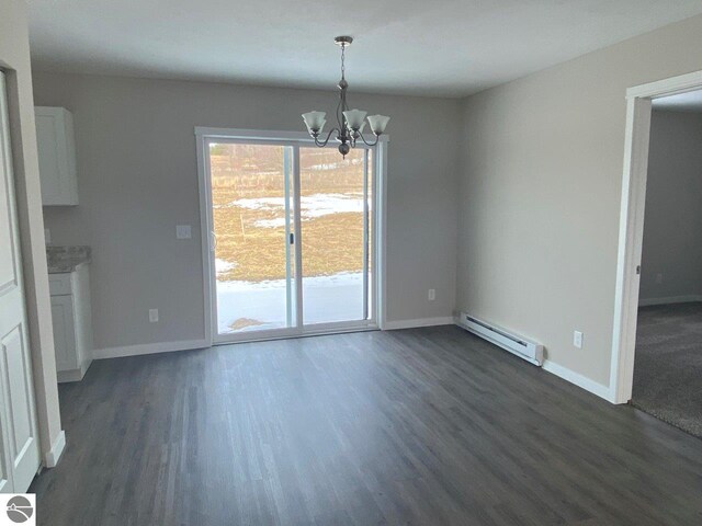 unfurnished dining area with dark wood-type flooring, a baseboard radiator, and an inviting chandelier