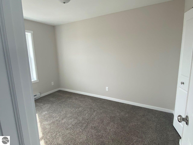 carpeted empty room featuring a baseboard radiator