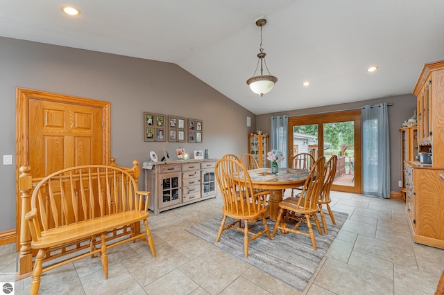 tiled dining room with vaulted ceiling