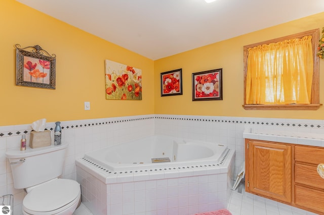 bathroom featuring tiled tub, vanity, tile patterned flooring, and toilet