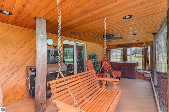 deck featuring a hot tub and ceiling fan