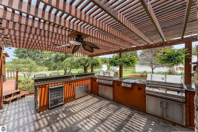 view of patio / terrace with area for grilling, wine cooler, and a pergola